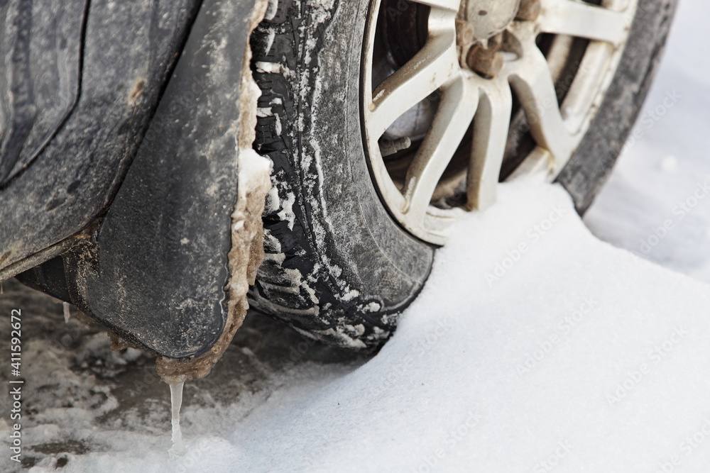 Car wheel on snow closeup, vehicle use on winter road Car wheel on snow closeup, vehicle use on winter road