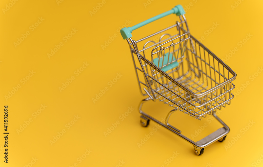 Empty shopping cart on yellow background. Empty shopping cart on yellow background.