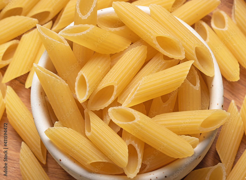 italian penne pasta from durum wheat close-up. Uncooked pasta italian penne pasta from durum wheat close-up. Uncooked pasta
