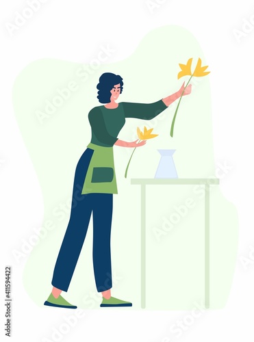 Woman compose bouquet on table. Forist shop or store.