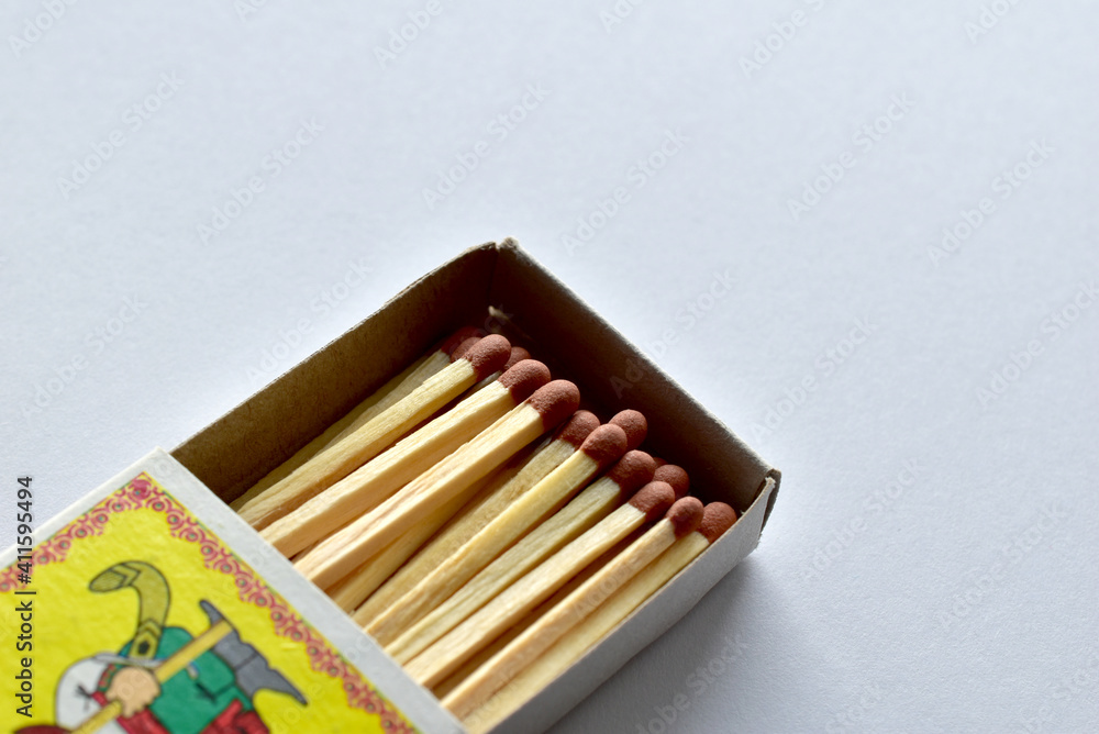 An open matchbox with matches lie on the table. An open matchbox with matches lie on the table.