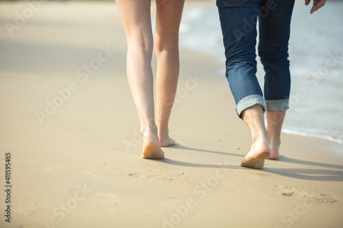 young couple walking on a beautiful sand beach