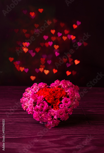 Big heart made of natural flowers. composition of flowers. Valentine's Day. red hearts on black isolated background