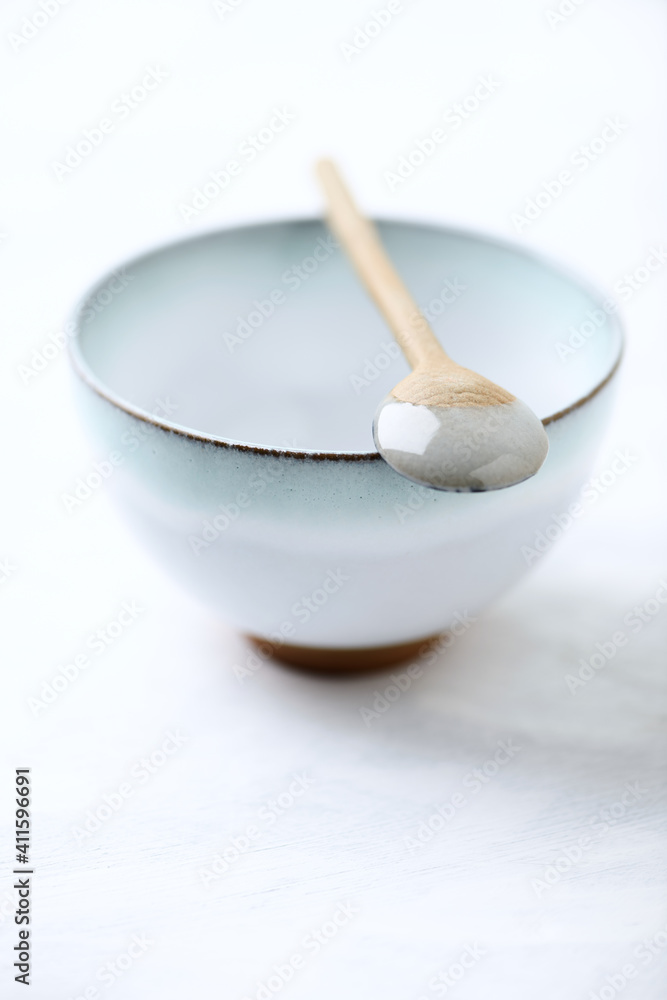 Traditional, handcrafted ceramic on bright wooden background. Soft focus. Close up. Traditional, handcrafted ceramic on bright wooden background. Soft focus. Close up.