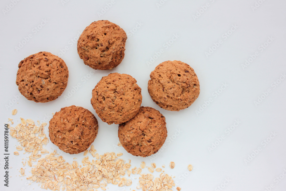 Homemade oatmeal cookies on white table. Overhead view of oat biscuits on white background with copy space