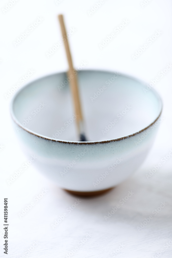 Traditional, handcrafted ceramic on bright wooden background. Soft focus. Close up. Traditional, handcrafted ceramic on bright wooden background. Soft focus. Close up.
