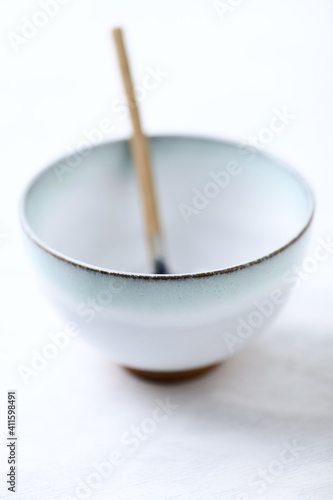 Traditional, handcrafted ceramic on bright wooden background. Soft focus. Close up.