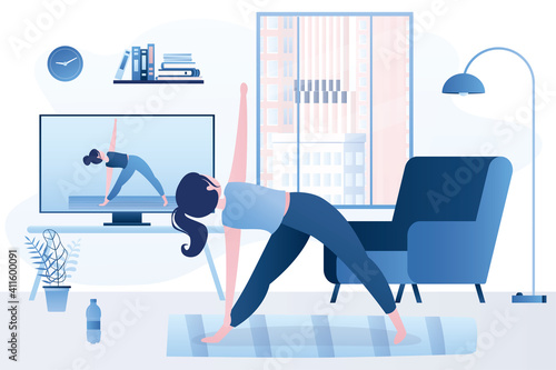 Online yoga course on tv screen. Beauty woman standing in triangle pose. Video lessons technology , remote workout. Fitness at home