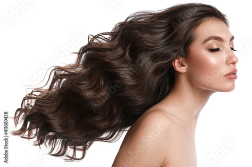 Beautiful brown-haired girl with a perfectly curls hair, and classic make-up. Beauty face and hair.