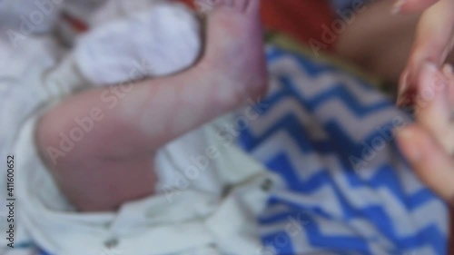 mom makes an impression, an imprint of a child's foot on photographic paper.