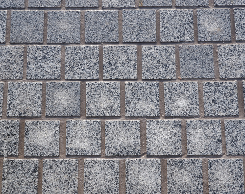 Gray  granite  square paving stones. Natural chipped stone.