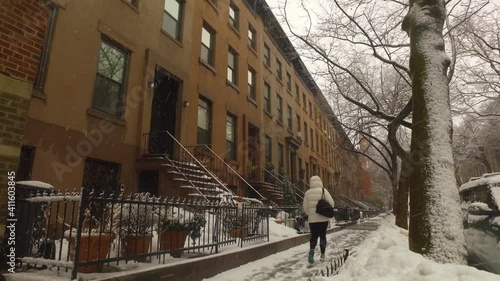 Wallpaper Mural person walks past Brooklyn brownstones during snow storm Torontodigital.ca