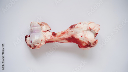 Canvas-taulu Large raw bone of big animal cow or pig on white background, top view, copy space