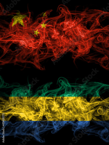 China  Chinese vs Gabon  Gabonese  Gabonian smoky mystic flags placed side by side. Thick colored silky abstract smoke flags.