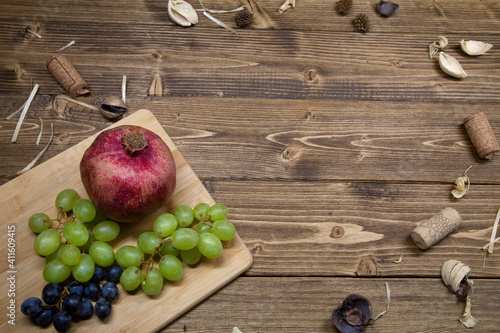 Wooden background with fruits and wine corks.