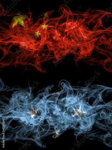 China, Chinese vs Micronesia smoky mystic flags placed side by side. Thick colored silky abstract smoke flags.