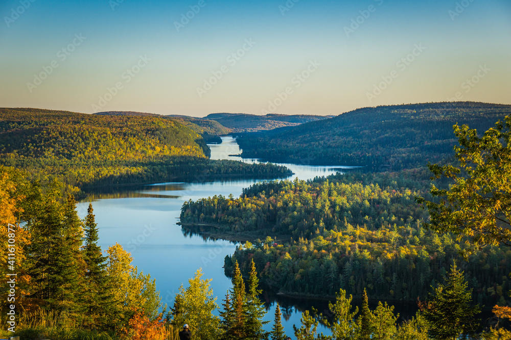 Obraz premium View on the Wapizagonke lake at sunset on a fall day from a belvedere in the Mauricie National Park (Quebec, Canada)