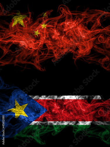 China, Chinese vs South Sudan smoky mystic flags placed side by side. Thick colored silky abstract smoke flags.