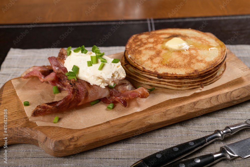 Pancakes with bacon and cheese on a wooden board Pancakes with bacon and cheese on a wooden board