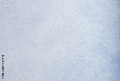 Abstract gray-blue background of smeared mixed color paint on a flat surface.