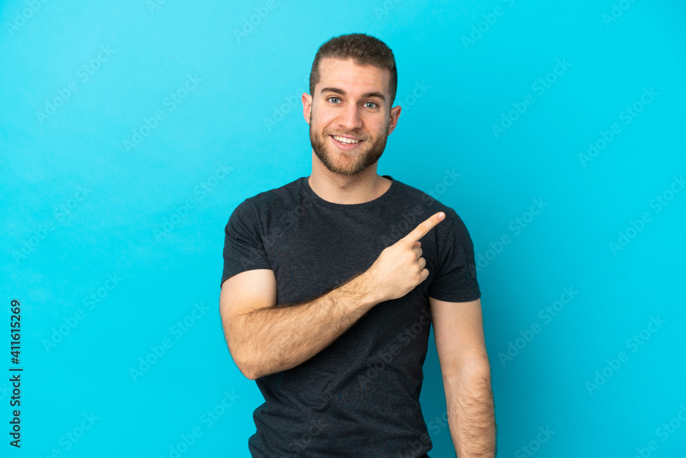 Young handsome caucasian man isolated on blue background pointing to the side to present a product Young handsome caucasian man isolated on blue background pointing to the side to present a product