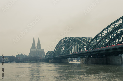 panorama of Cologne with cathedral and hohenzollern bridge at snowy weather. rhine river with high water © Stockhausen