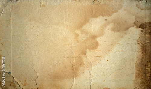 The texture of old yellowed cardboard with spots.