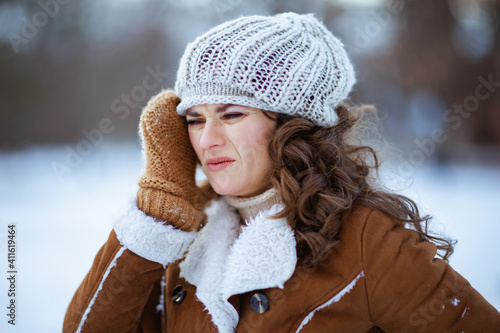 stressed modern woman outside in city park in winter