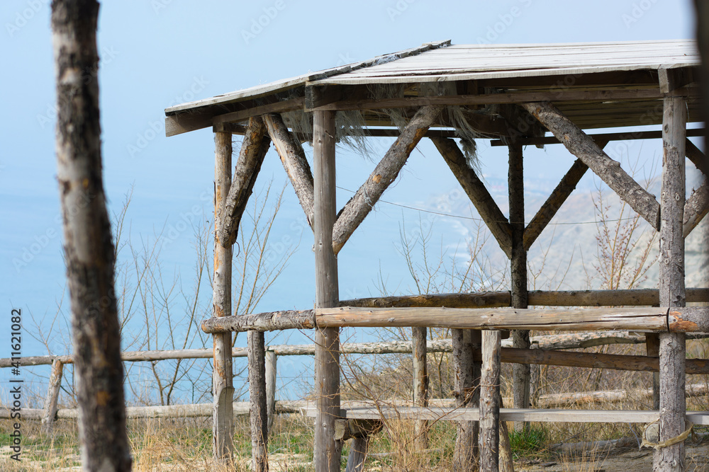 Homemade gazebo from a wooden log house