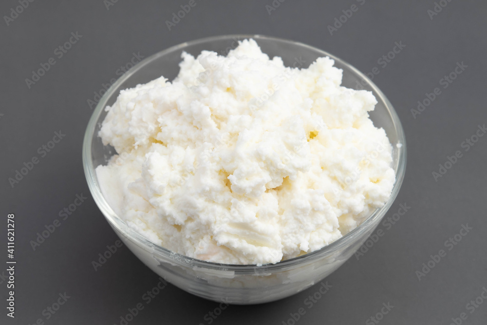 Traditional Indian Churned White Butter Also Known As Safed Makhan Malai Or Homemade Makkhan Is Used To Prepare Desi Ghee In Crystal Glass Bowl. Isolated On Grey Background With Copy Space For Text Traditional Indian Churned White Butter Also Known As Safed Makhan Malai Or Homemade Makkhan Is Used To Prepare Desi Ghee In Crystal Glass Bowl. Isolated On Grey Background With Copy Space For Text