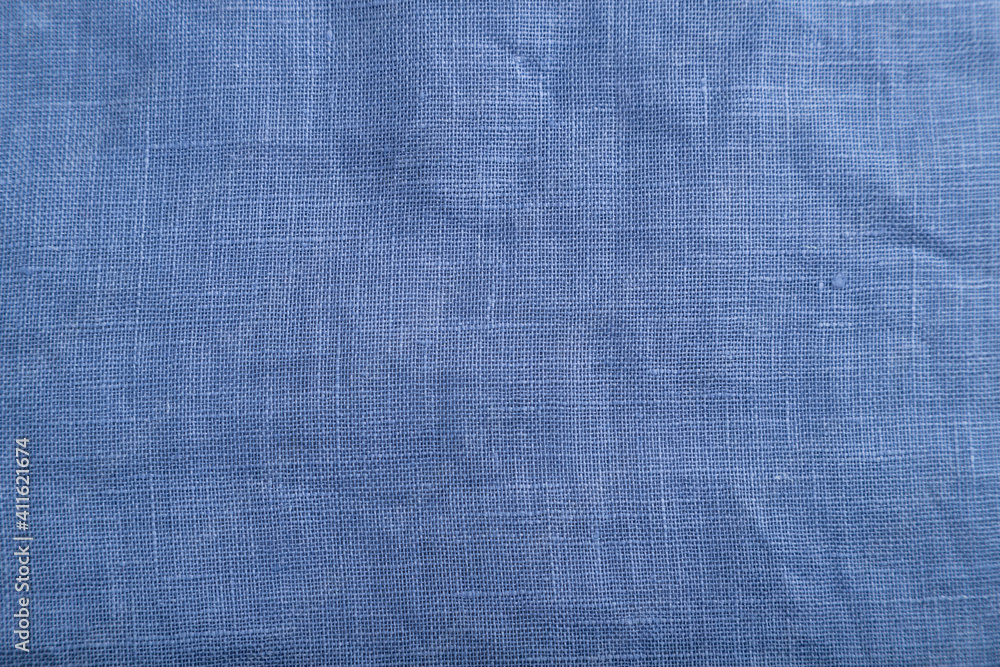 Fragment of smooth blue linen tissue. Top view, natural textile background. Fragment of smooth blue linen tissue. Top view, natural textile background.