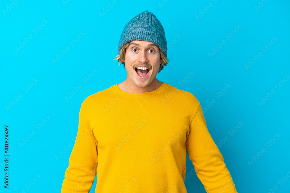 Handsome blonde man isolated on blue background with surprise facial expression Handsome blonde man isolated on blue background with surprise facial expression