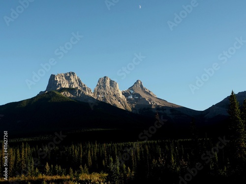 Three Sister with moon in background view at Trans Canada Highway near Canmore Alberta Canada OLYMPUS DIGITAL CAMERA
