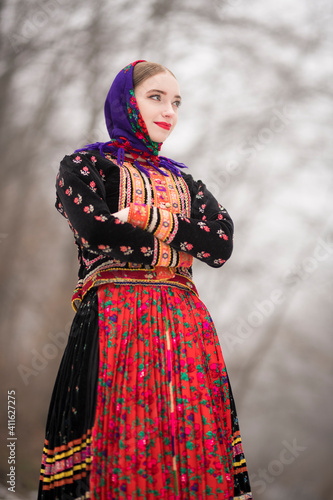 Slovak folklore. Traditional folk costume. Beautiful folk dancer in winter.