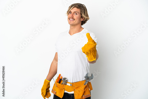 Young electrician blonde man isolated on white background doing coming gesture