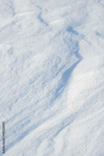 Fresh clean white snow background texture. Winter background with frozen snowflakes and snow mounds. Snow lumps. Seasonal landscape details. Cold weather.