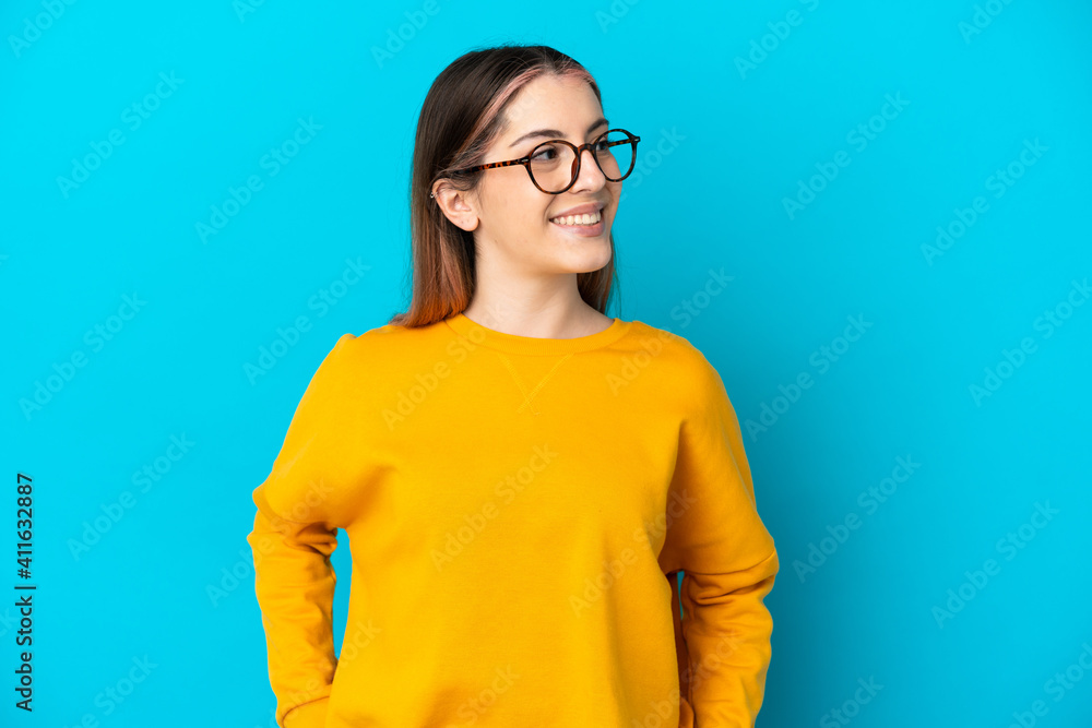 Young caucasian woman isolated on blue background thinking an idea while looking up Young caucasian woman isolated on blue background thinking an idea while looking up