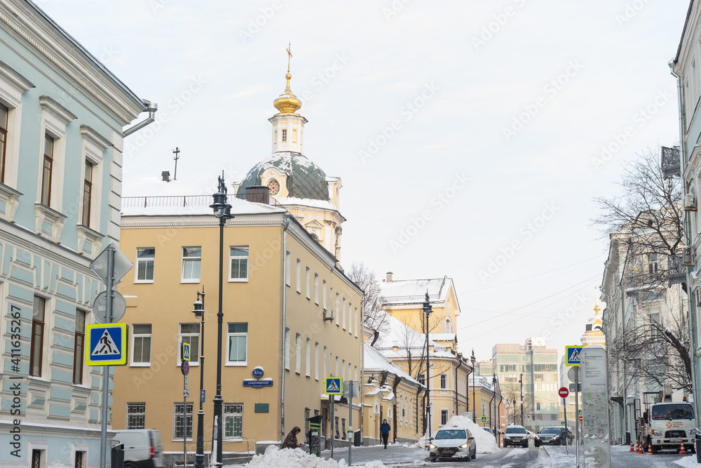 Moscow, Russia, Jan 15, 2021: Zvonarsky side street. Winter. Piles of snow. St' Nicolas church.