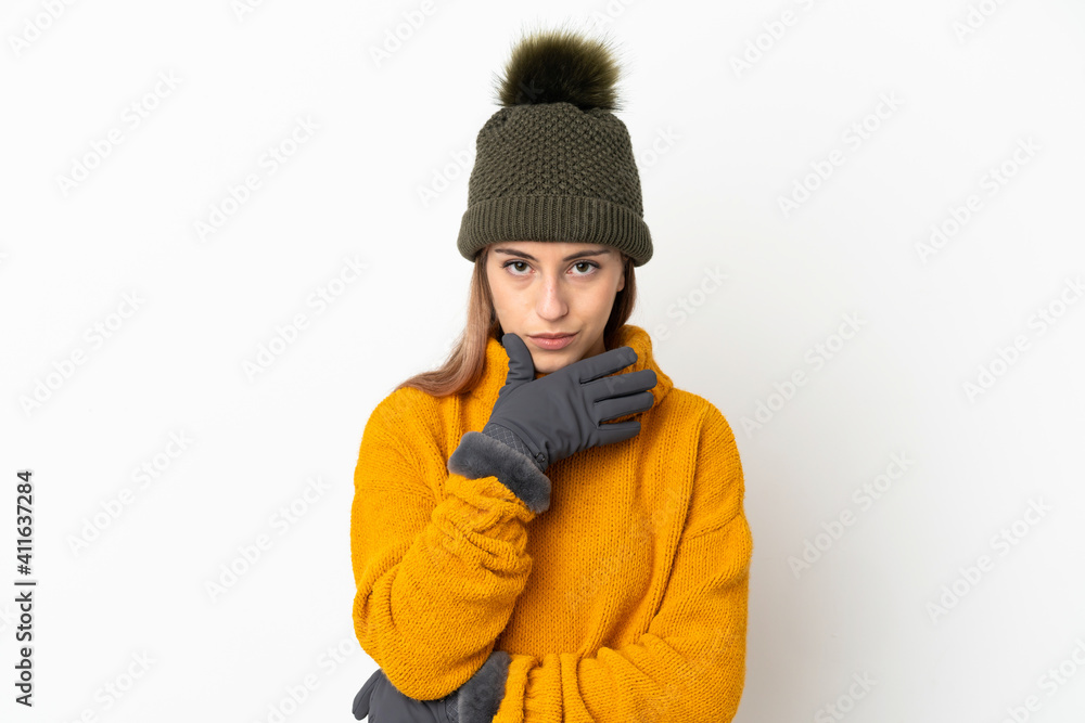 Young girl with winter hat isolated on white background thinking Young girl with winter hat isolated on white background thinking