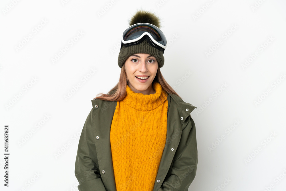 Skier caucasian woman with snowboarding glasses isolated on white background with surprise facial expression