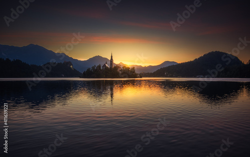 Obraz na płótnie Little Island with Catholic Church in Bled Lake, Slovenia at Sunrise with Castle and Mountains in Background w salonie