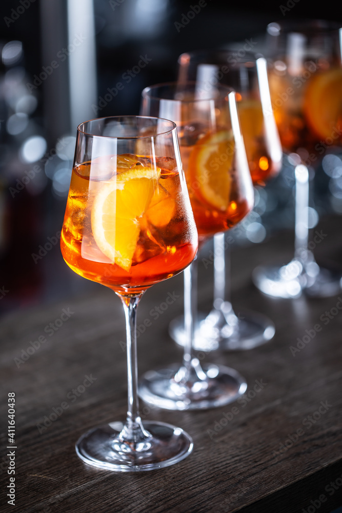 Typical summer sekt drink aperol spritz served in wine glasses with aperol,  prosecco, soda and a slice of orange Stock-Foto | Adobe Stock