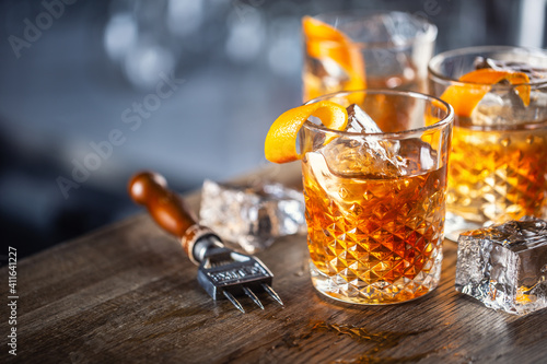 Bild auf Leinwand Old fashioned classic rum cocktail on ice with orange zest garnish