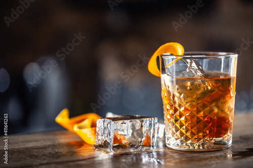 Tela Old fashioned rum drink on ice with orange zest garnish