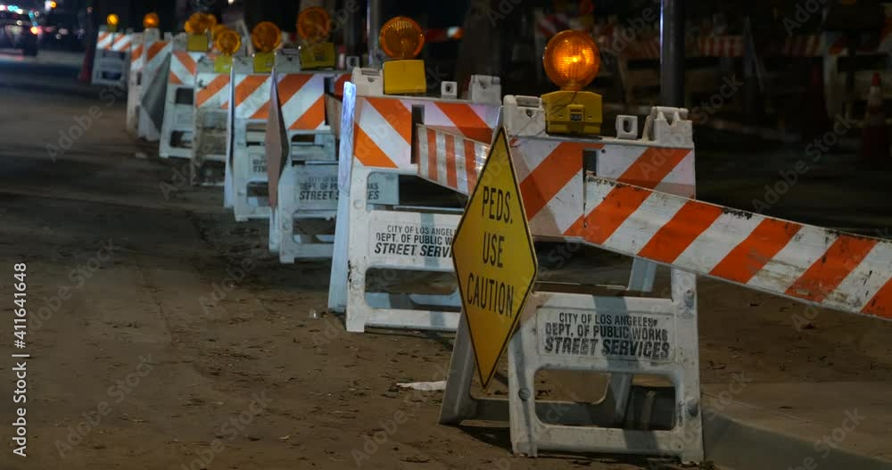 Flashing yellow light on caution signs in a construction zone at night