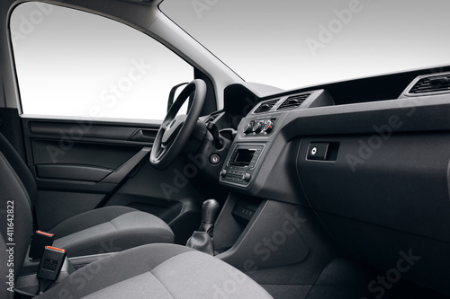Modern SUV car interior with the leather panel, multimedia, and dashboard, at the isolated background © Moose