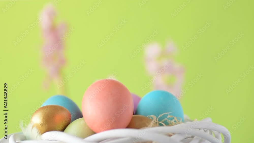 Easter eggs in straw spin on green background Easter eggs in straw spin on green background