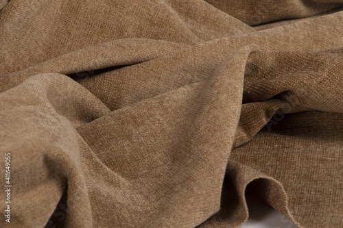 Closeup of a wrinkled natural bro chenille fabric texture