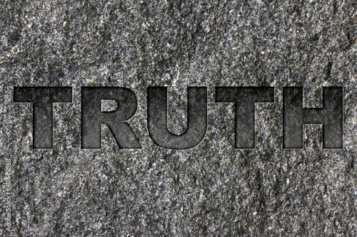 Truth etched in bold, dark gray text on black granite.