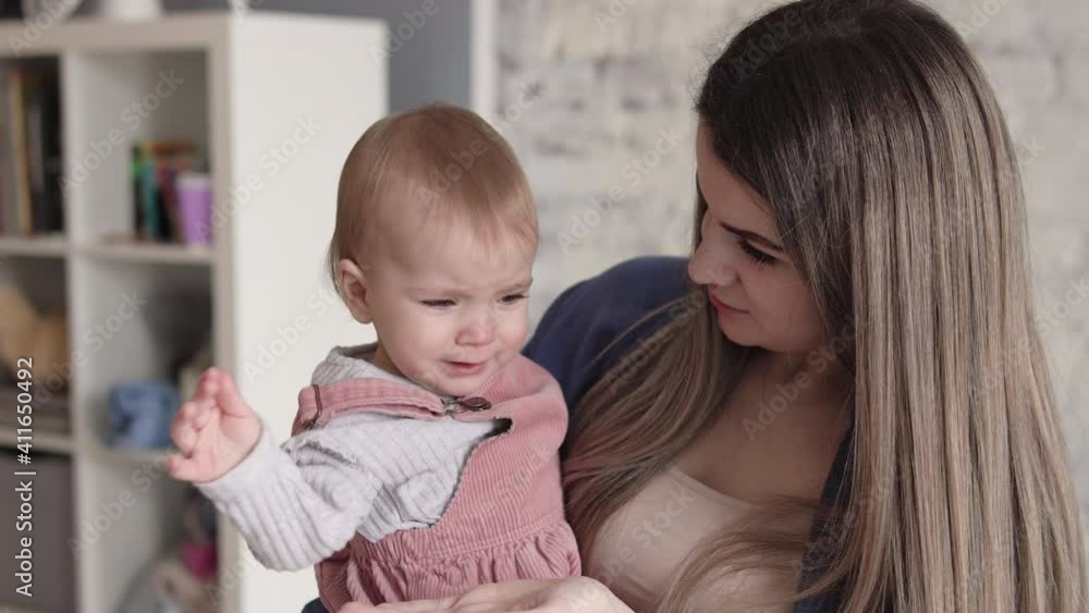 Anxious mother trying to calm down her capricious unhappy child who crying Anxious mother trying to calm down her capricious unhappy child who crying